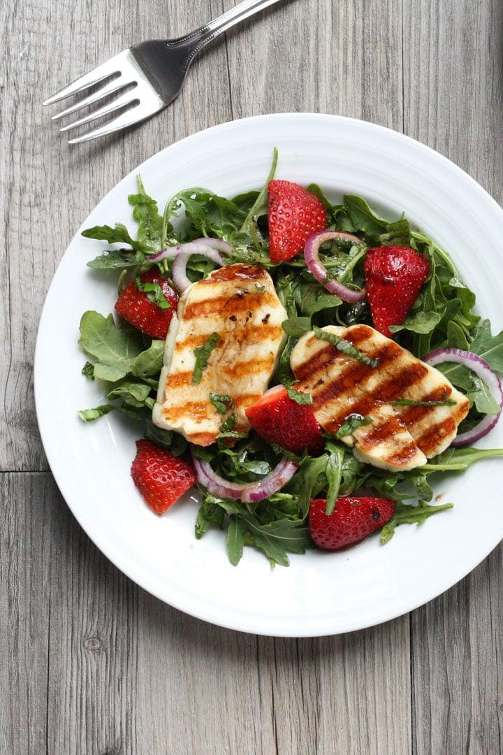 close-up of grilled halloumi in strawberry spinach salad