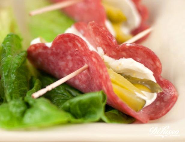 deli counter with cheese, salami, and pickles