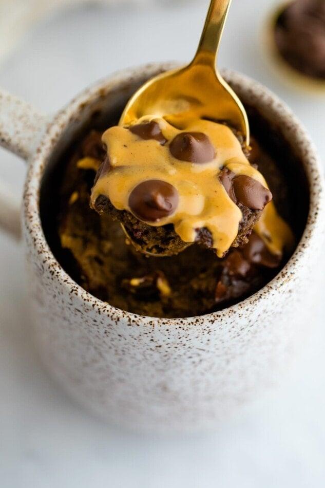 close up shot of a yuzu mug cake with a spoon taking a bite