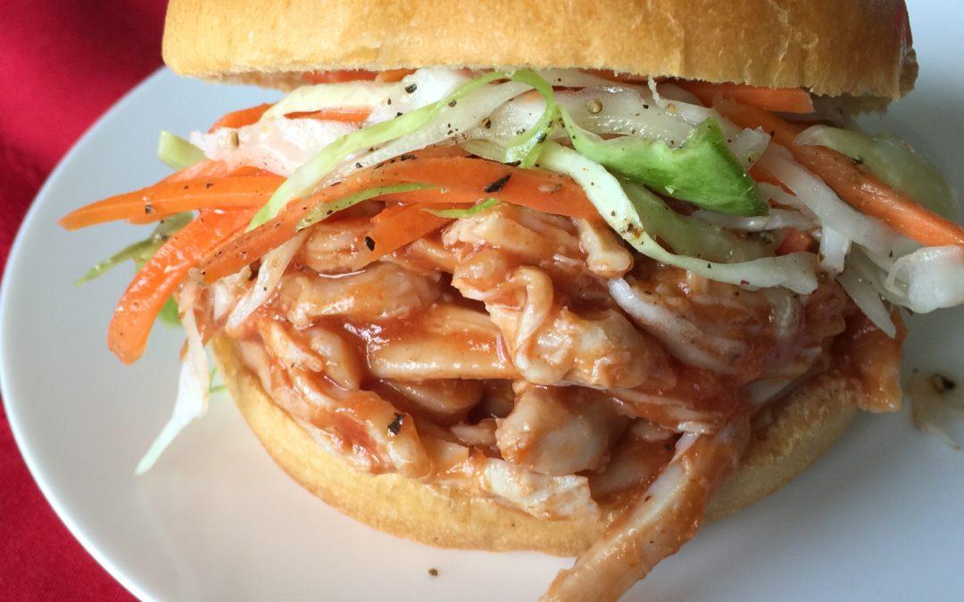 Peach BBQ Chicken sandwich on a bun at a campsite