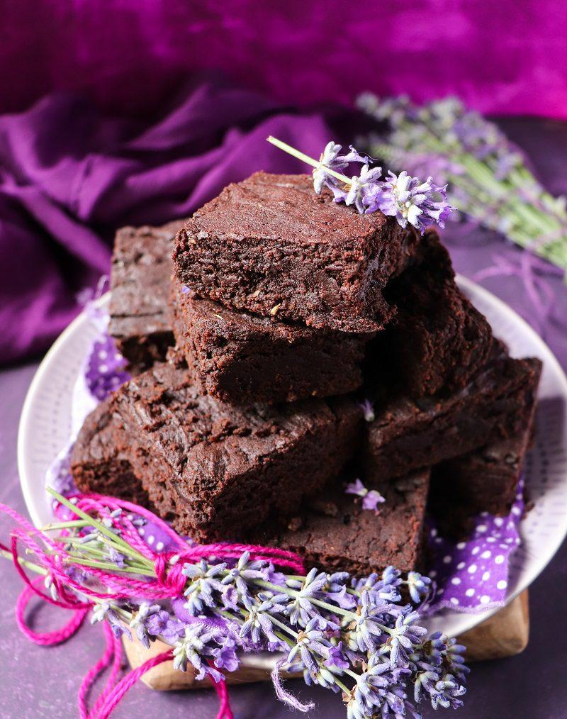 close-up of lavender honey being drizzled over a stack of brownies