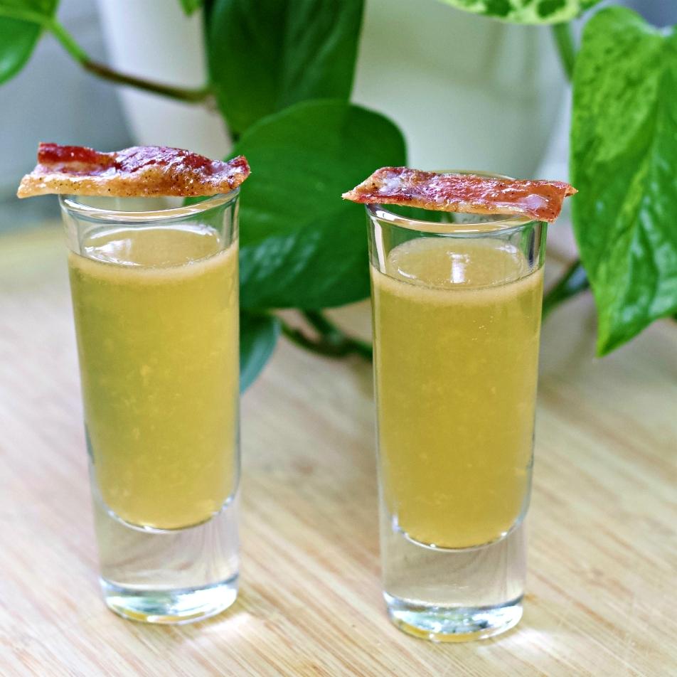 close up shot of blended bacon and date smoothie in a glass