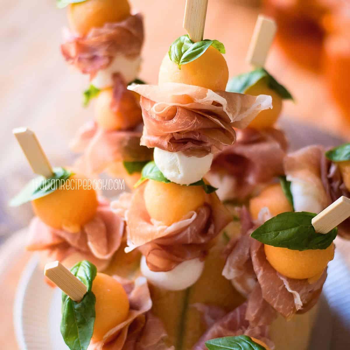 prosciutto wrapped melon skewers close up