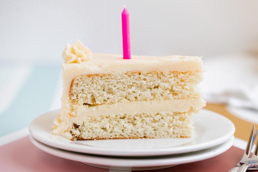 vanilla coconut flour birthday cake decorated with frosting and candles
