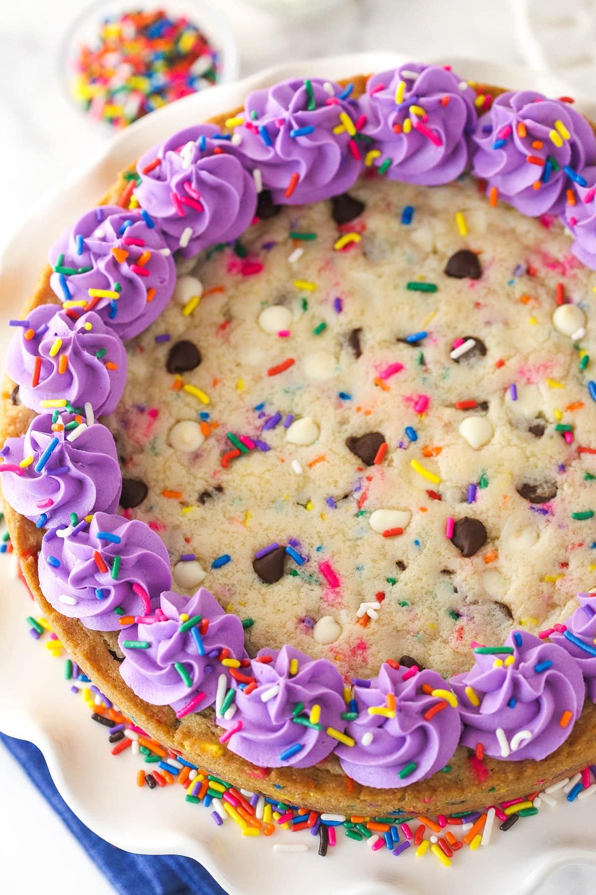 overhead shot of a graduation cookie cake decorated with icing and sprinkles