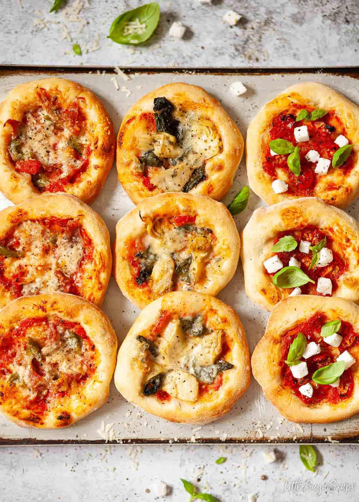 close-up shot of various pizza toppings laid out in small bowls