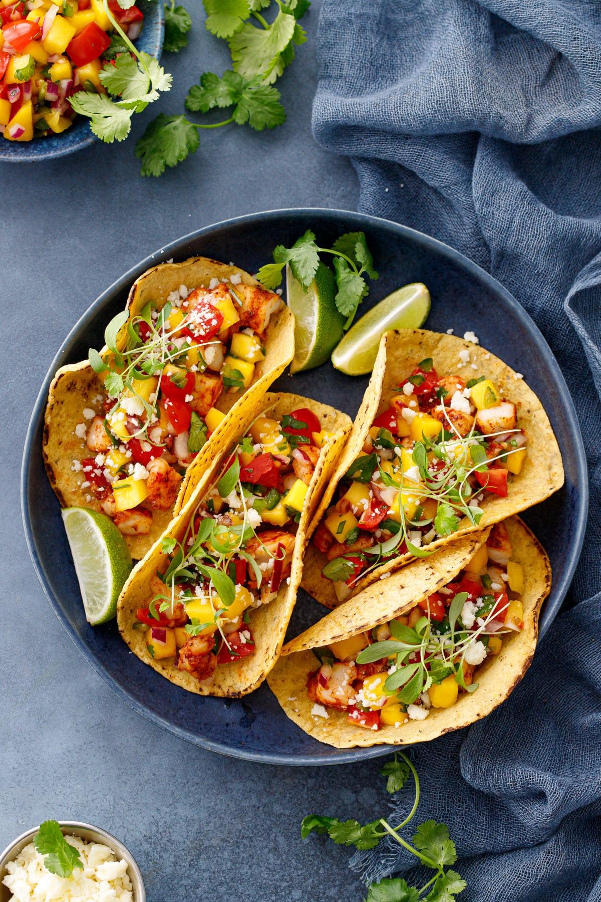 grilled shrimp tacos topped with mango salsa