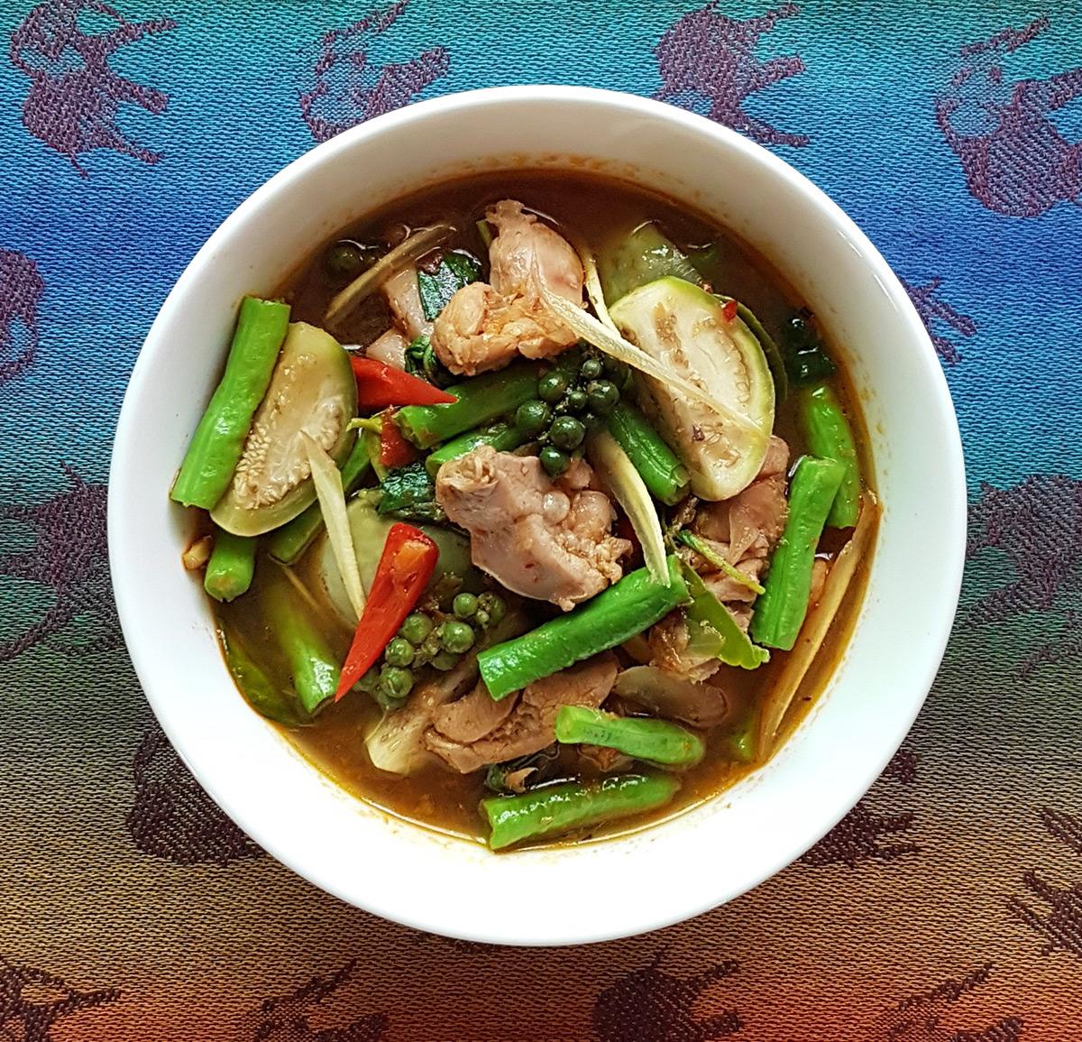 spicy jungle curry with wild boar and fresh herbs