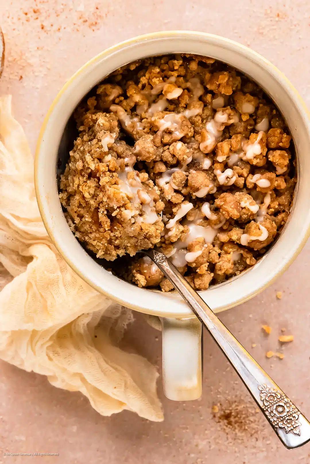 overhead shot of a salted caramel swirl mug cake with various toppings