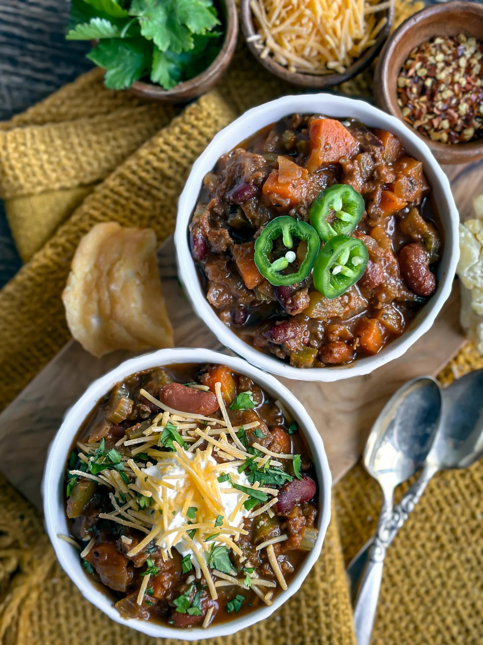 Rustic bowl of bubbling chili-garlic beef stew, garnished with fresh cilantro, steam rising, warm lighting