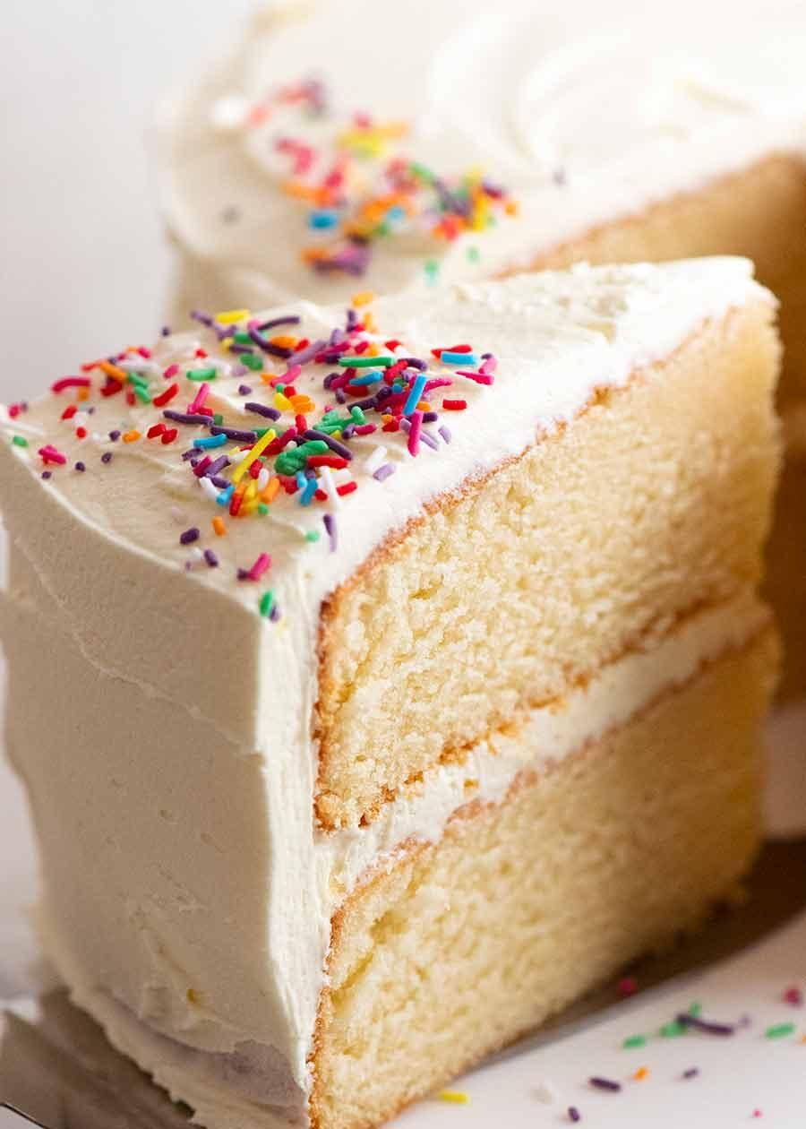 A close-up of a slice of vanilla birthday cake showing the moist crumb