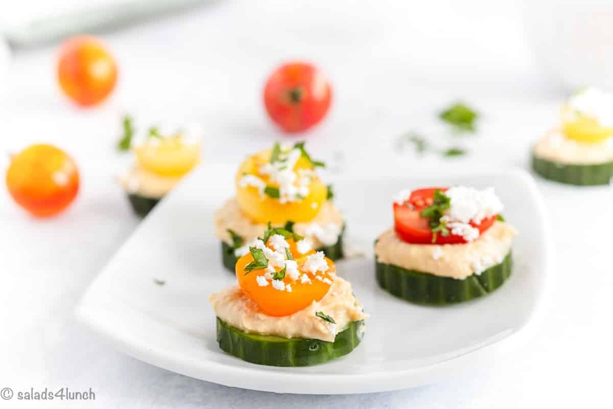 close up of cucumber hummus bites on a plate