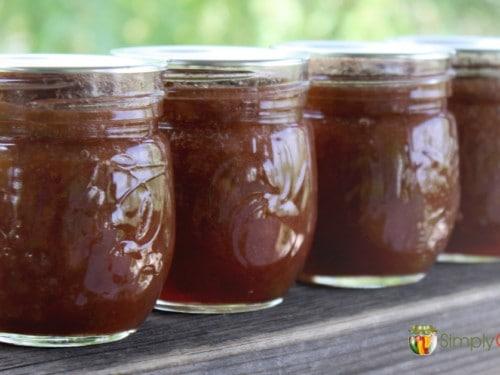jars of homemade Saffron Sun Rhubarb Jam, some open to show the texture