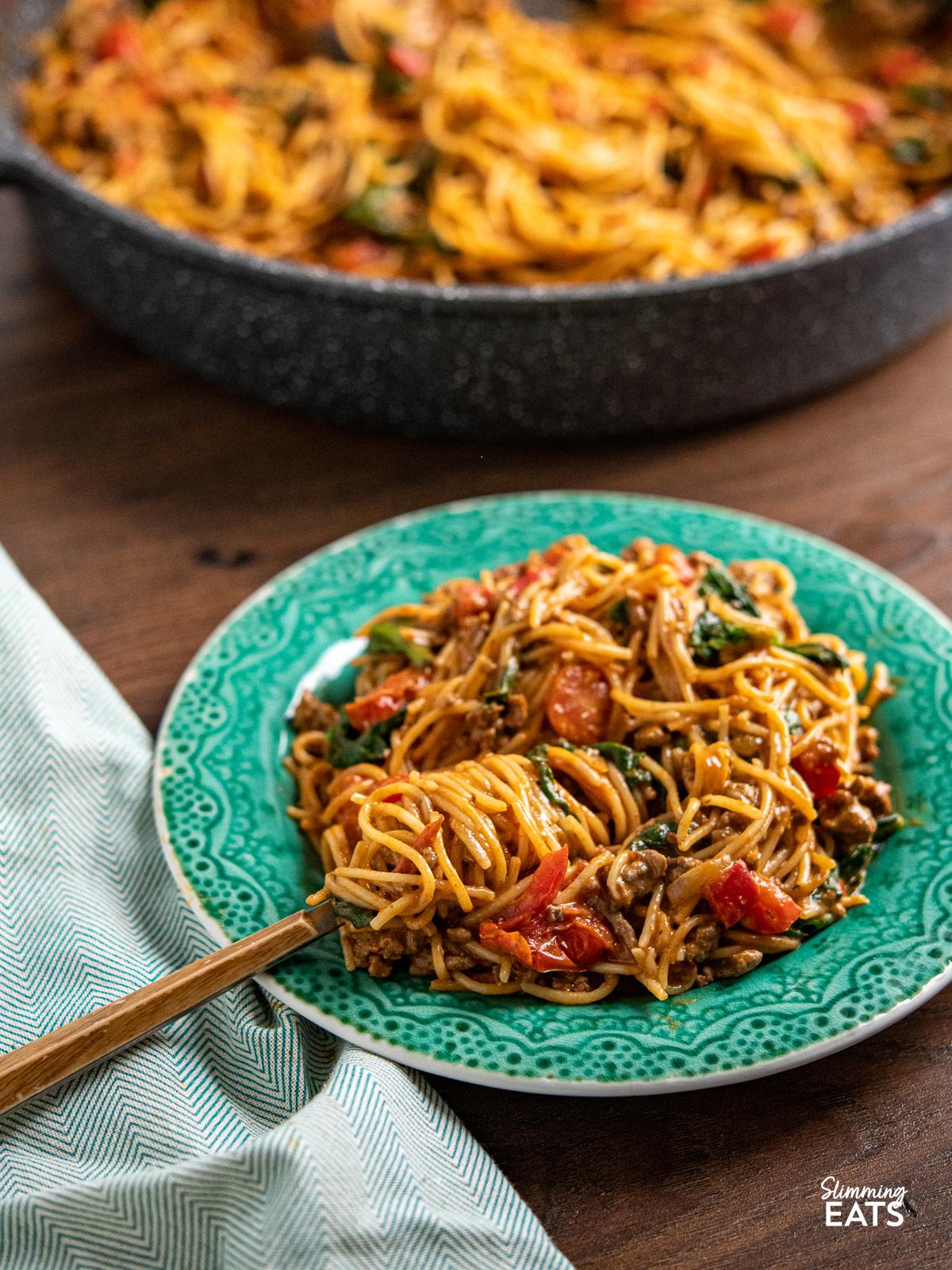 ground beef cooking in a pan with harissa paste