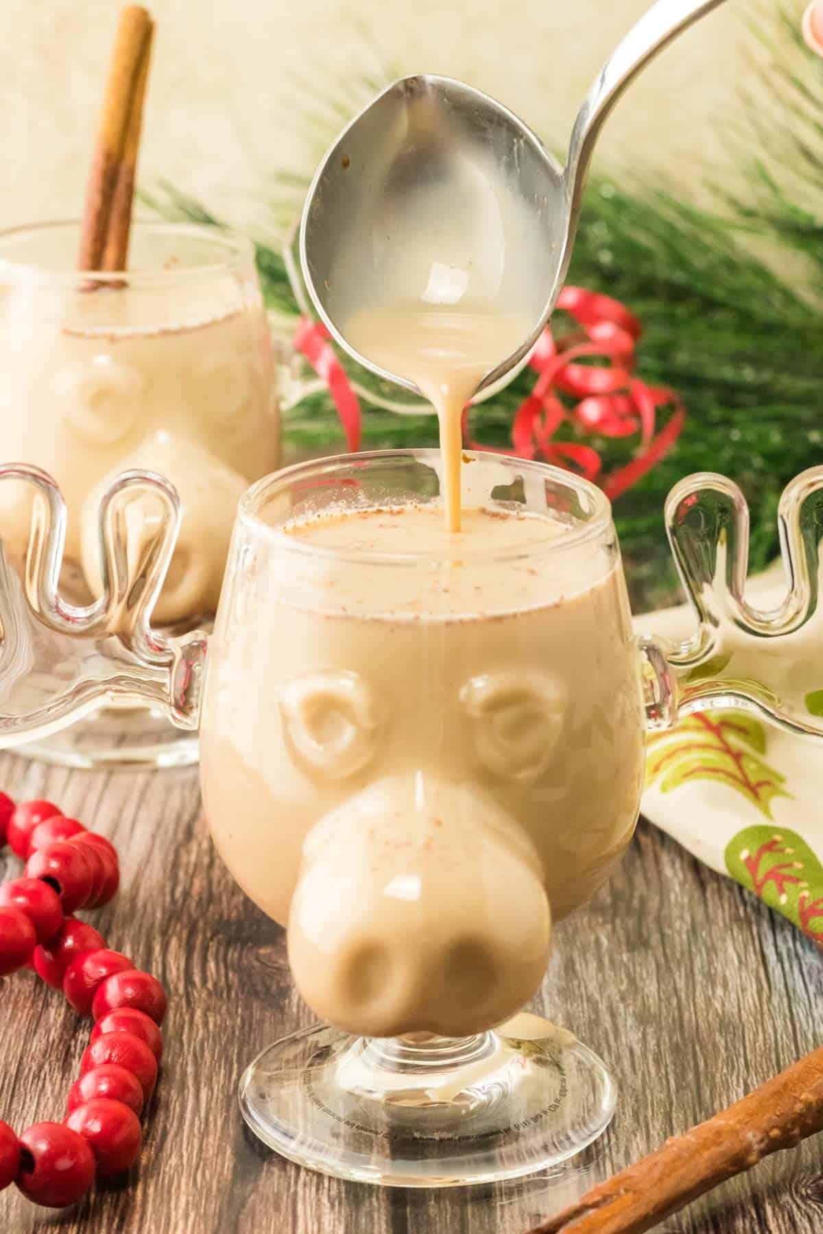 homemade eggnog being poured into a glass