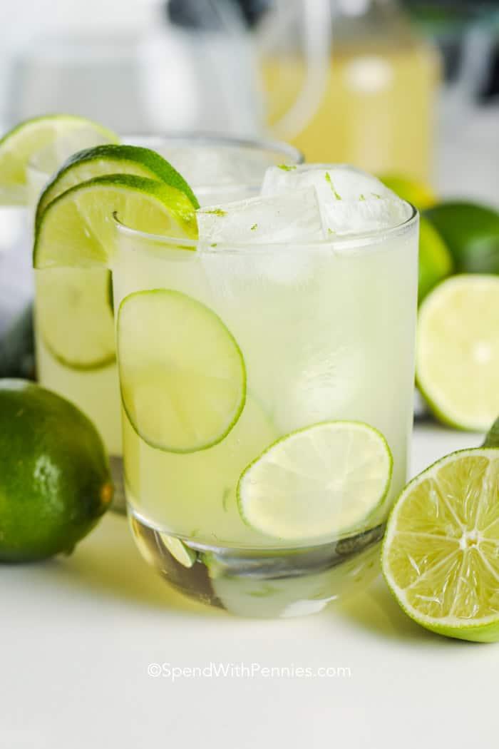 pitcher of homemade limeade with limes and ice