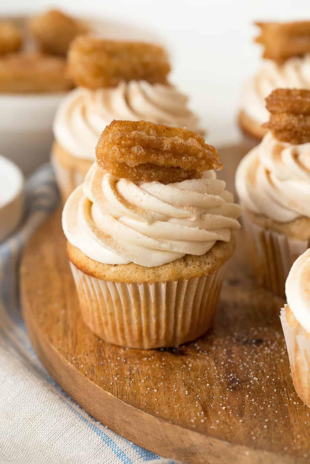 Mini churro cupcakes with cinnamon sugar topping and chocolate drizzle