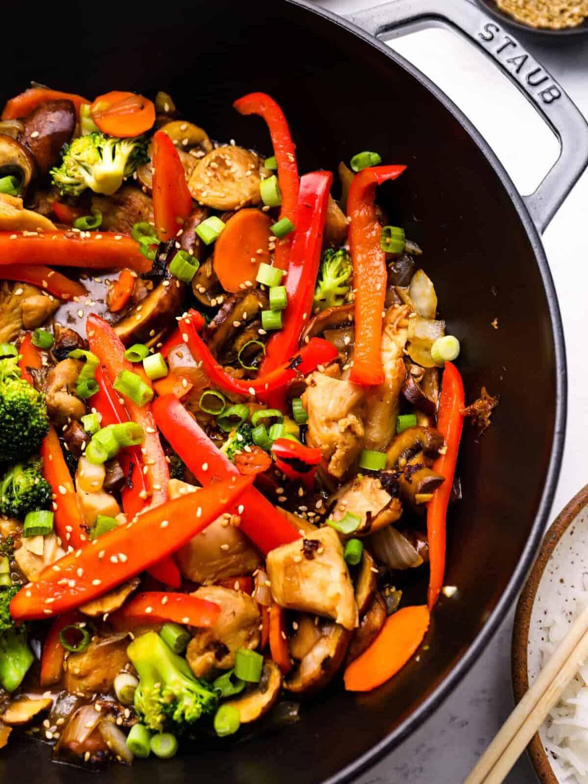 Close-up of spicy chicken being stir-fried in a wok