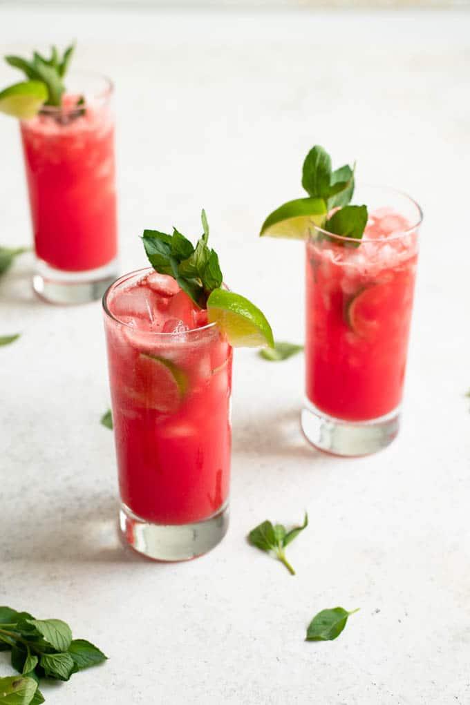 close up of a glass of watermelon agua fresca with mint leaves floating