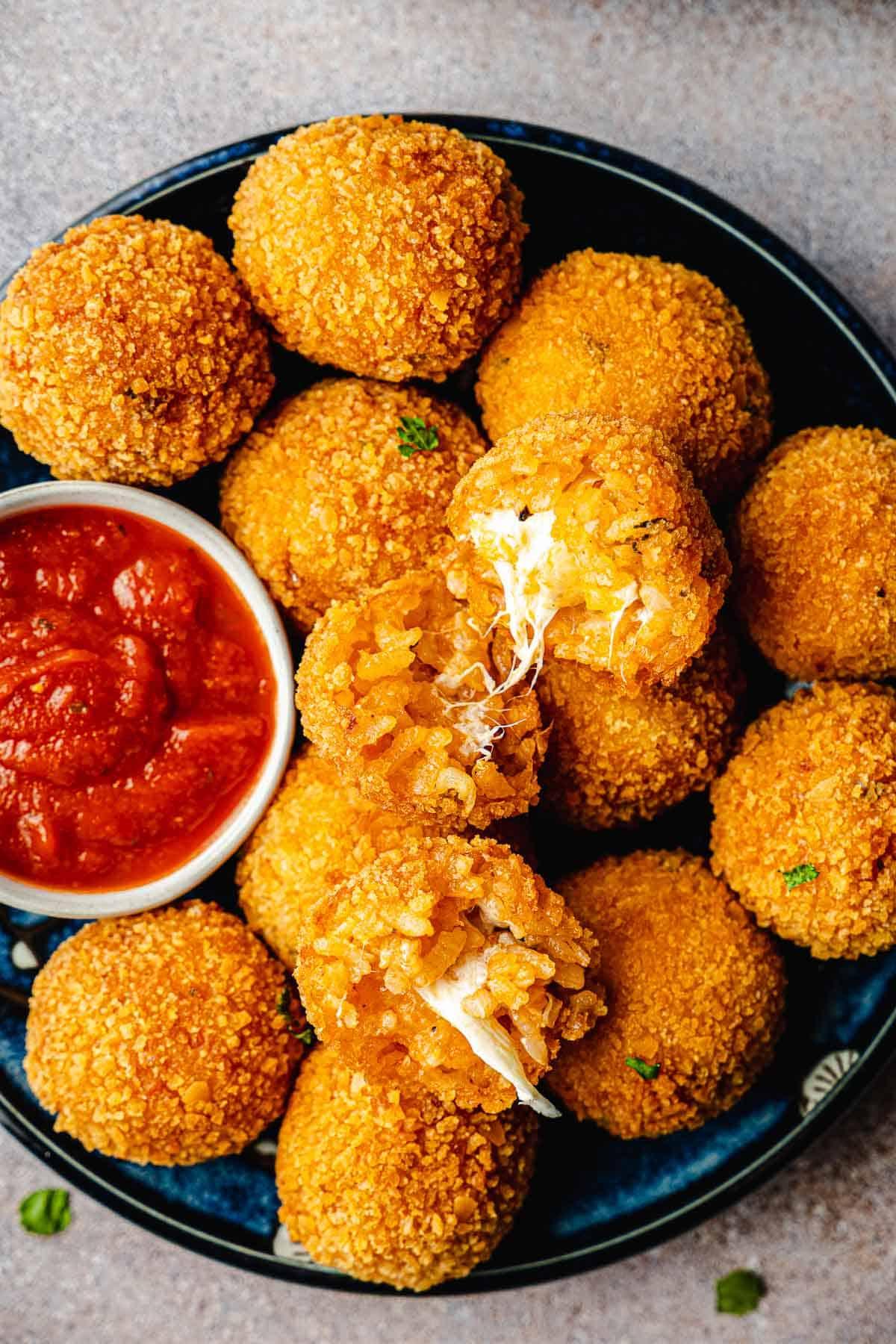 close up of a cheese arancini being fried