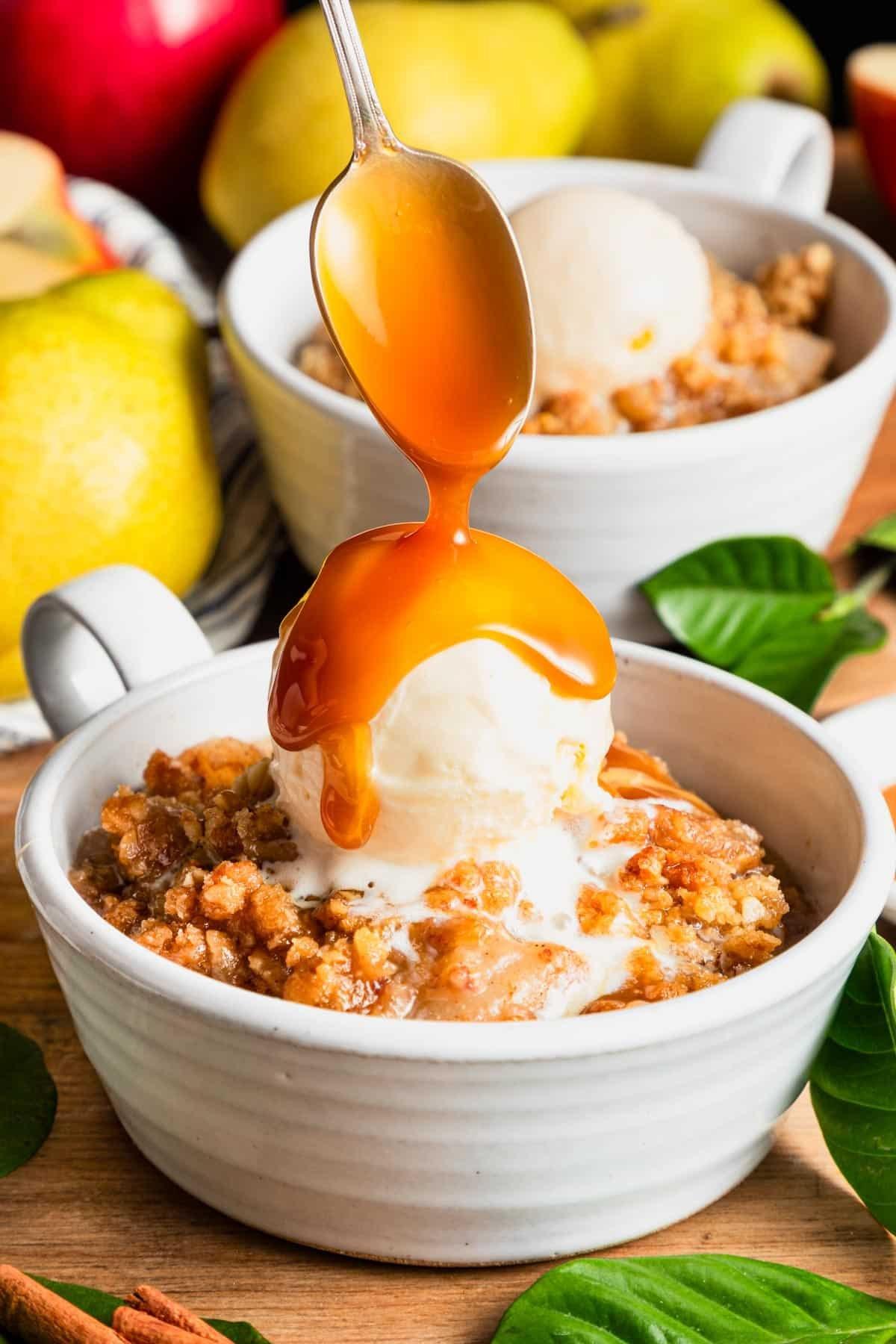 close-up of cinnamon pear crisp with a spoon scooping out a portion