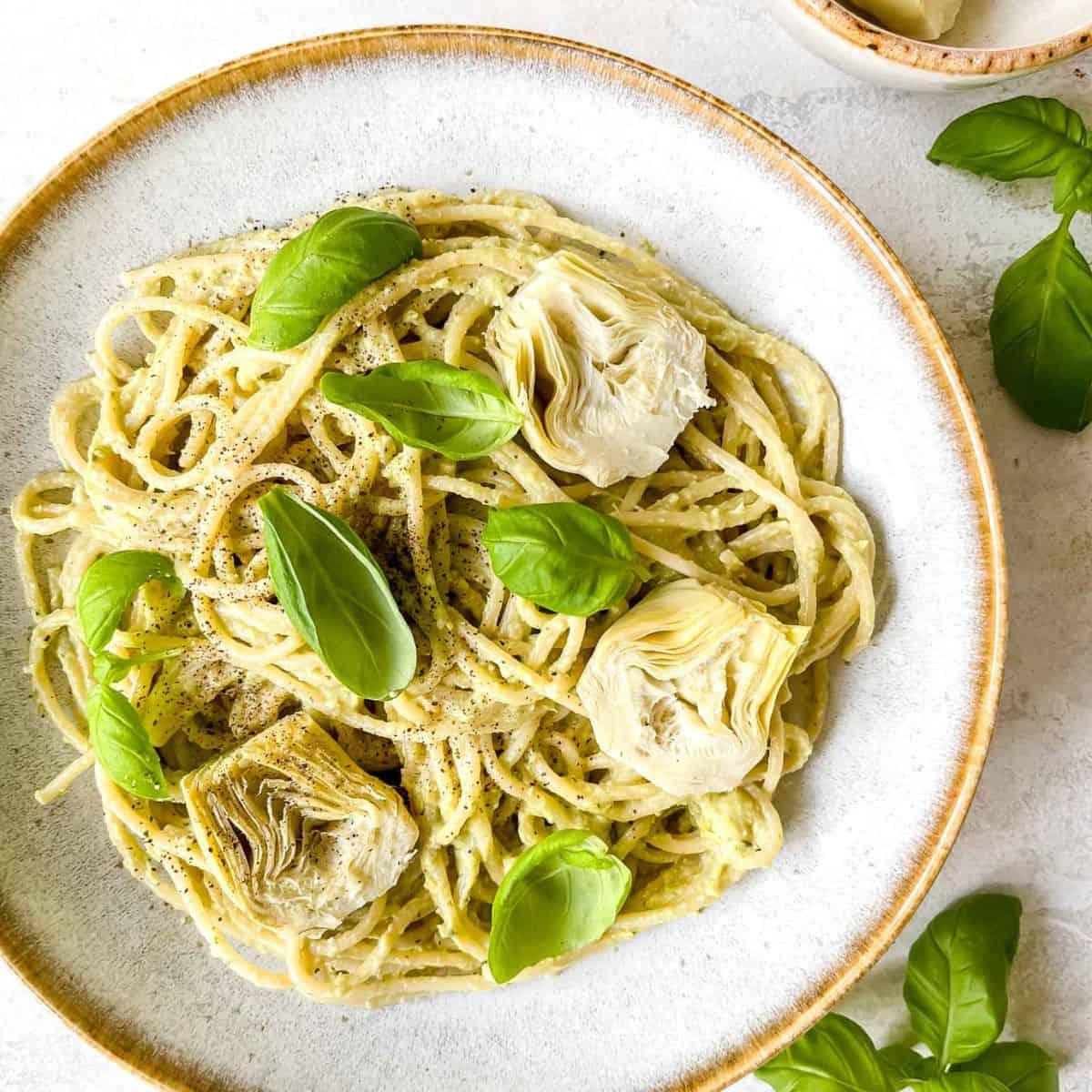 Pesto Pasta with Artichoke Hearts and Capers plating on a plate