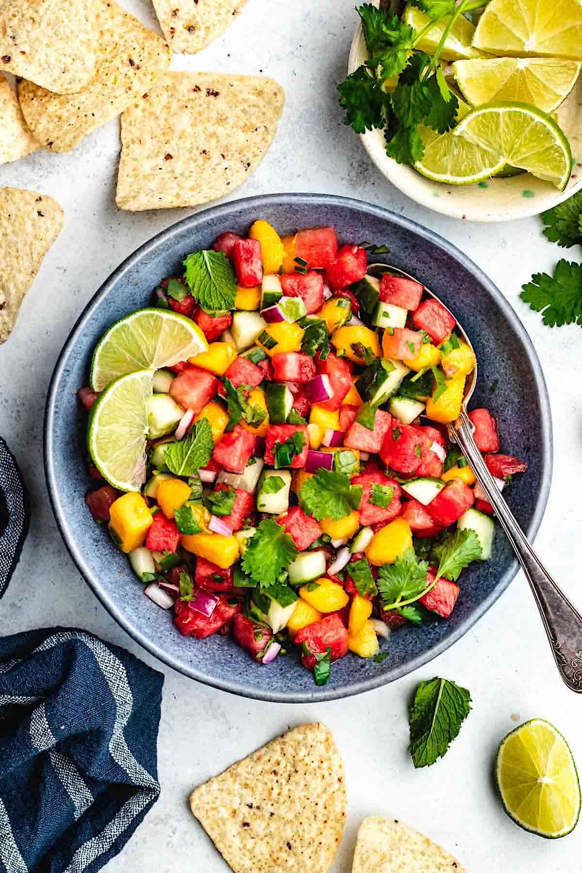 overhead shot of a bowl of watermelon mango salsa surrounded by tortilla chips