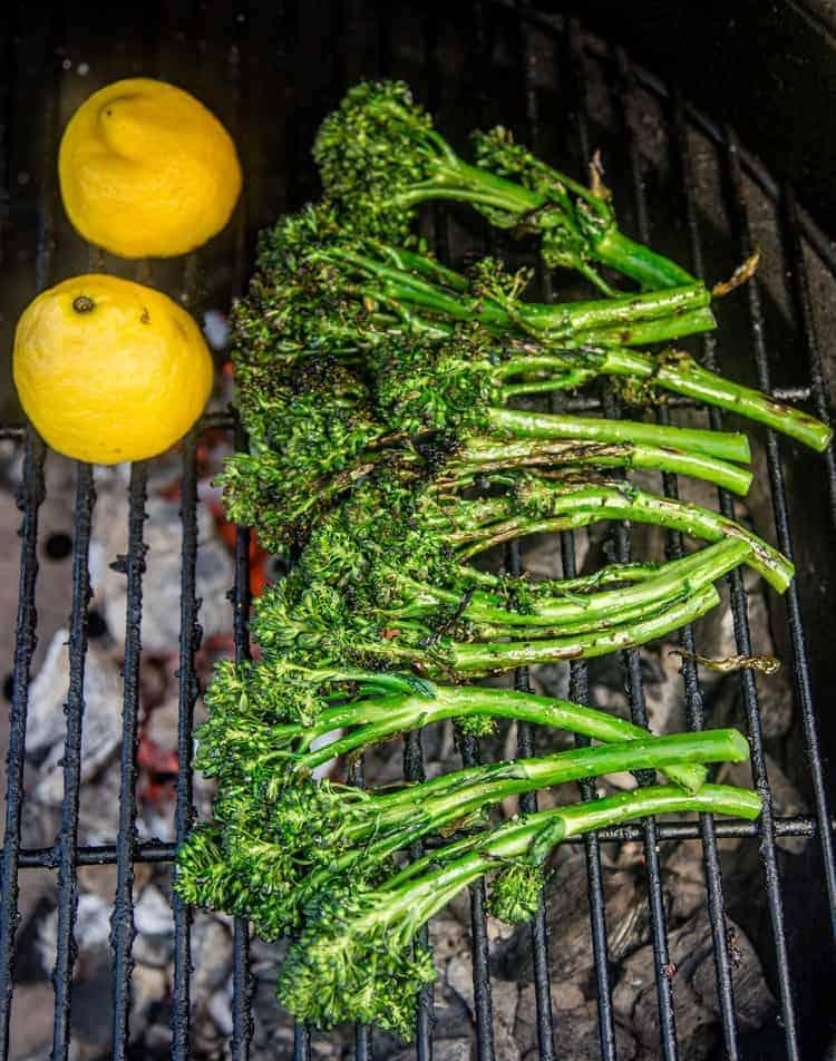 charred grilled broccolini on a grill grate