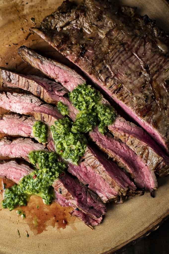 close-up of grilled flank steak slices with glaze drizzled on top