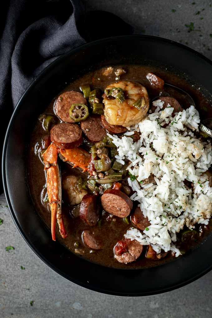 Steaming bowl of seafood gumbo with okra and andouille sausage