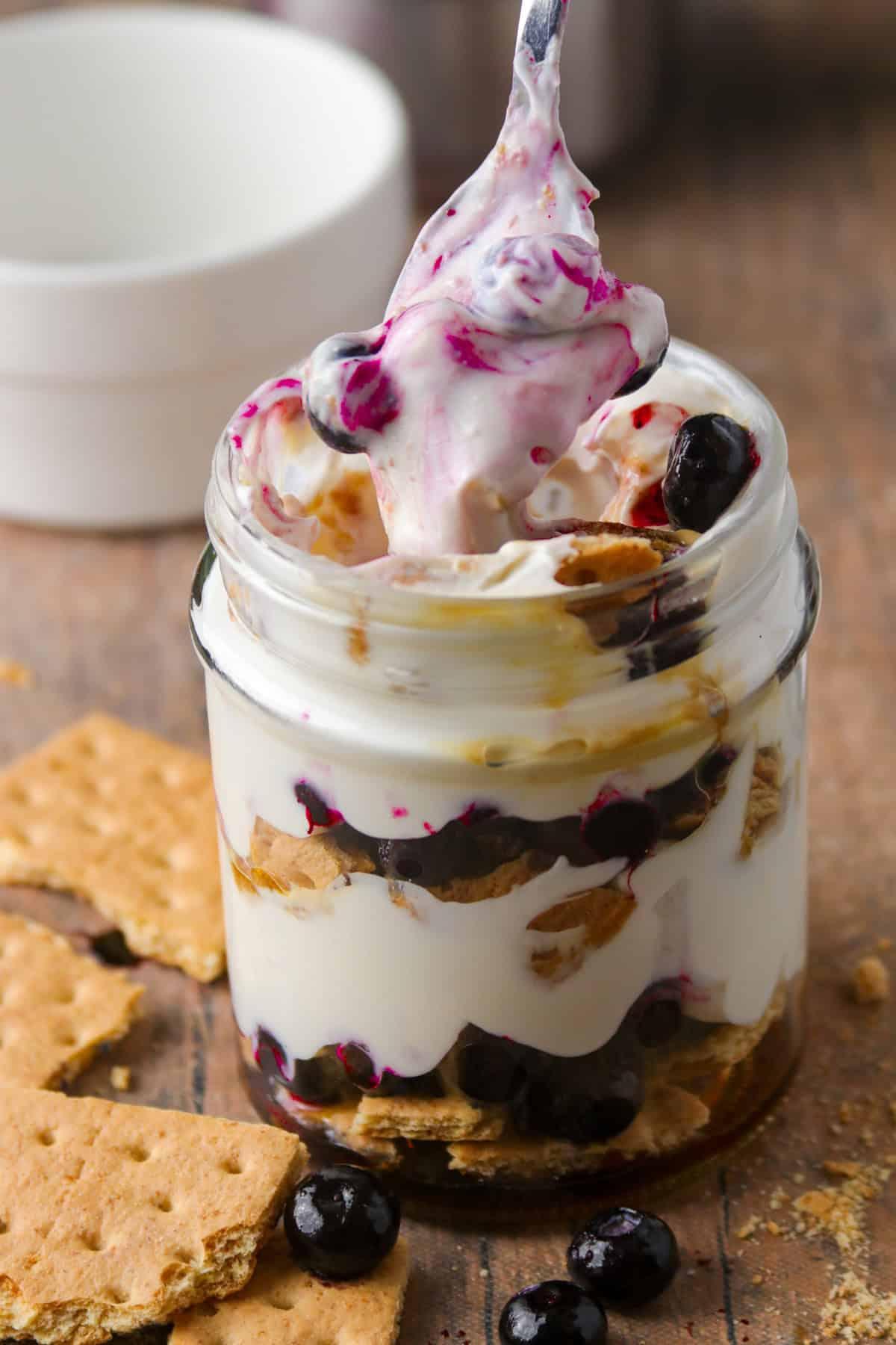 woman enjoying a parfait with a book