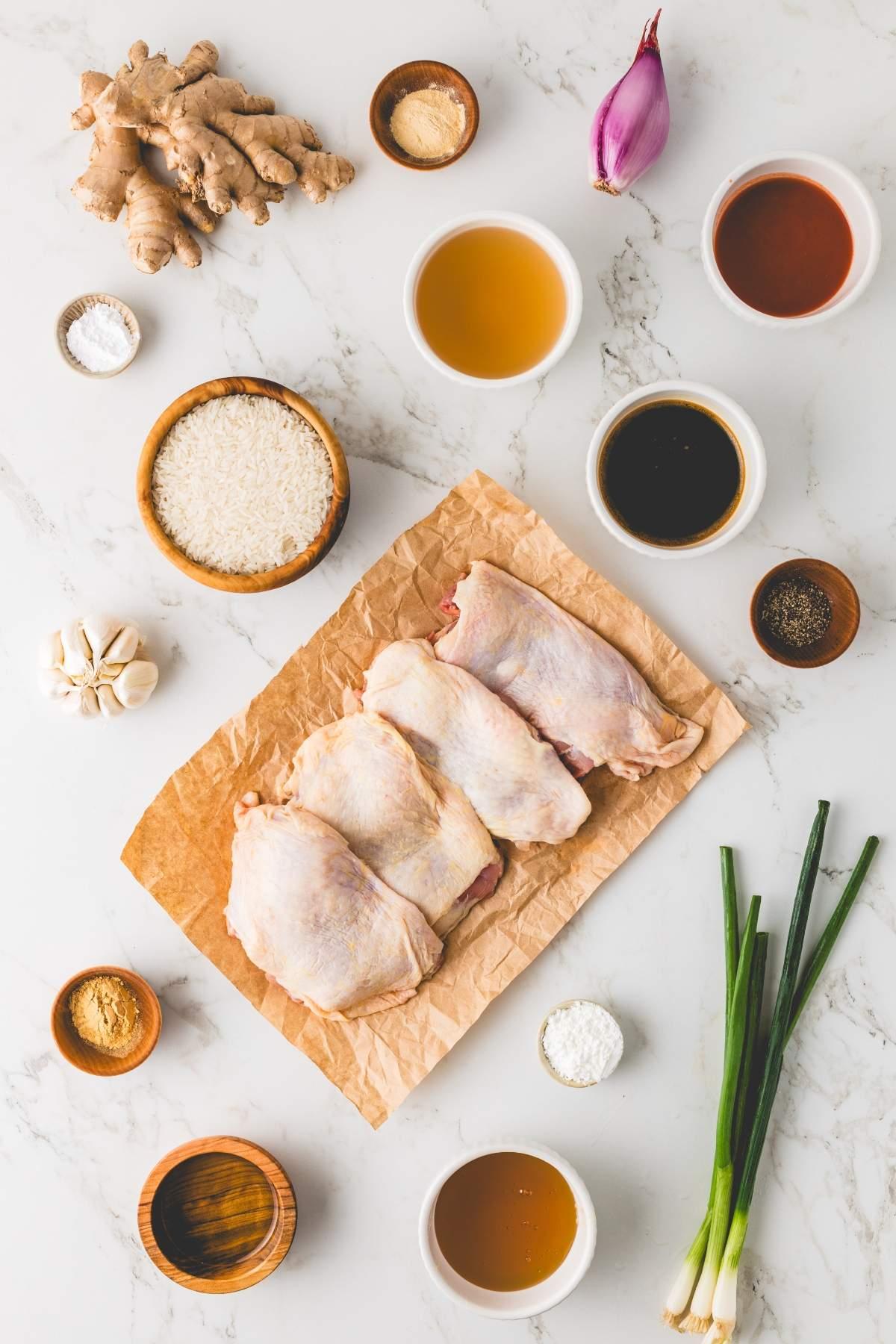Ingredients for white chicken chili with soy sauce and ginger laid out on a wooden table