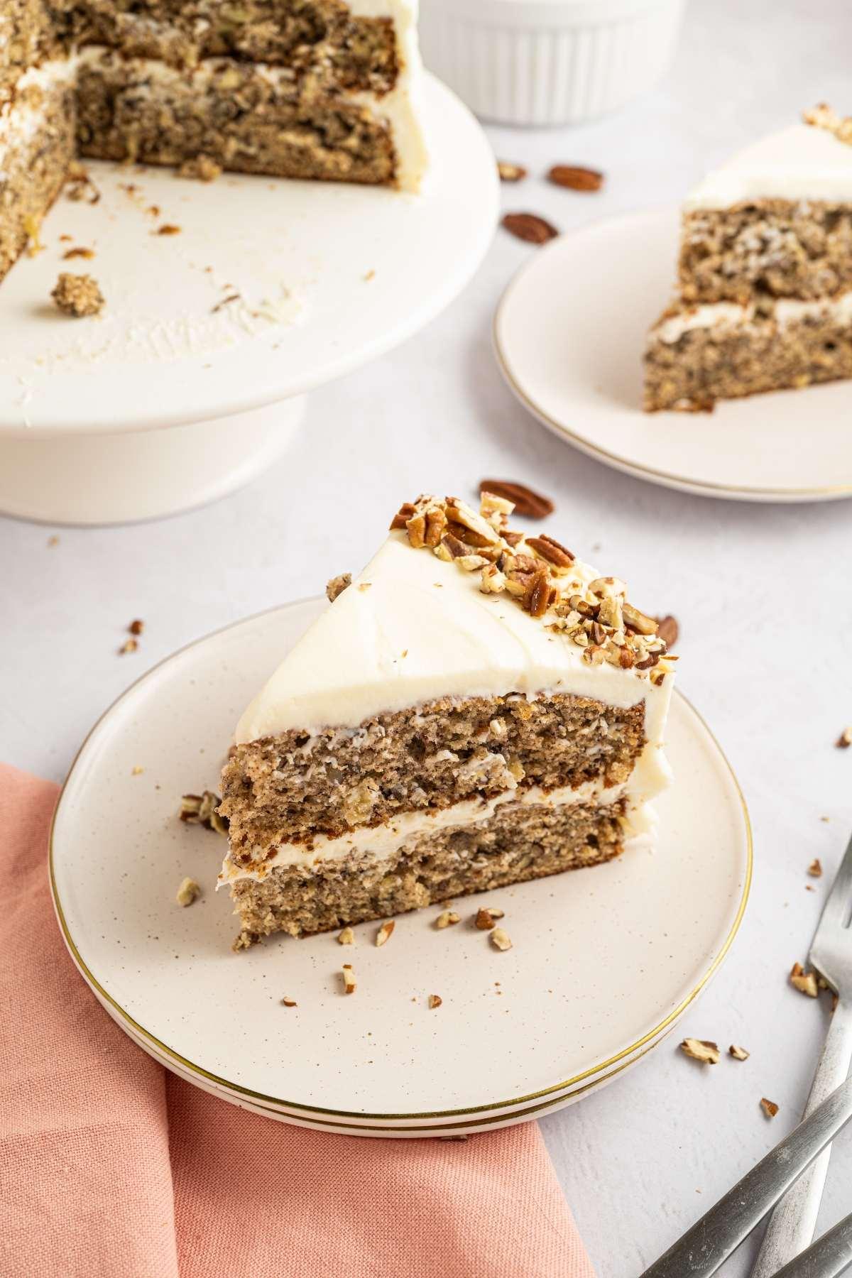 sliced nectarine hummingbird cake with cream cheese frosting on a plate