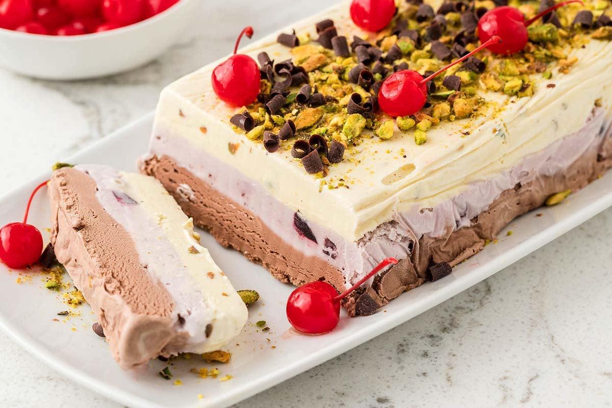 close-up shot of layered spumoni ice cream with visible pistachios and cherries