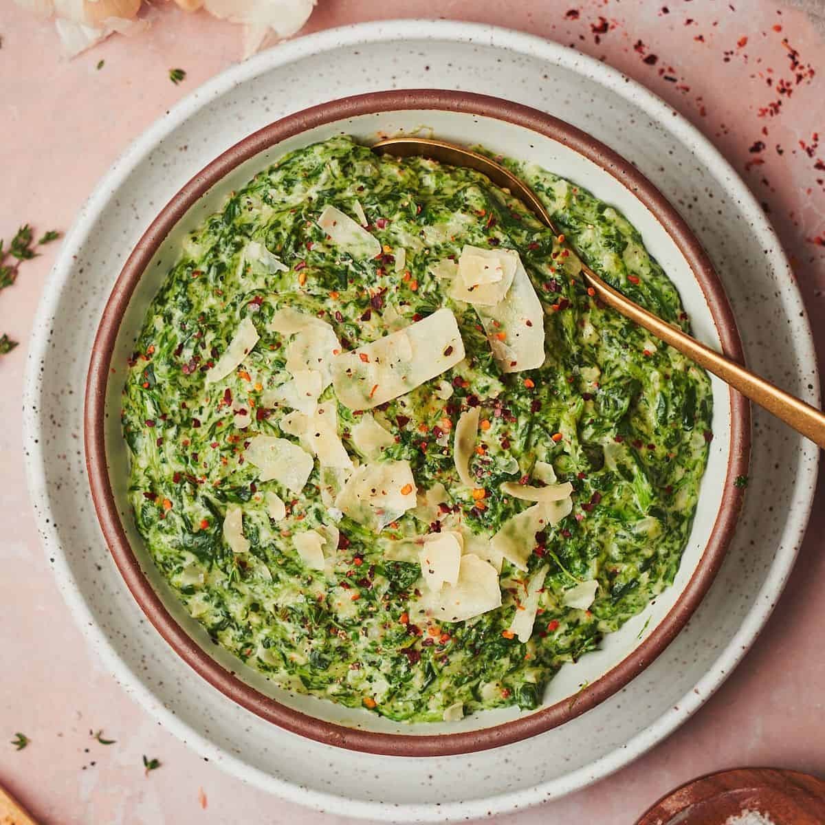 luscious creamed spinach in a rustic serving dish, side view
