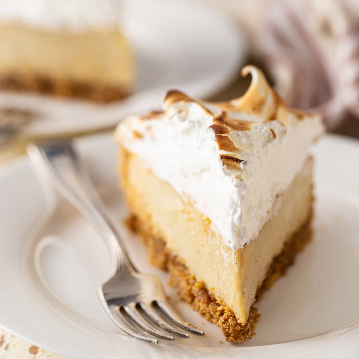 beautifully styled eggnog pie with fluffy nutmeg meringue topping on a festive table