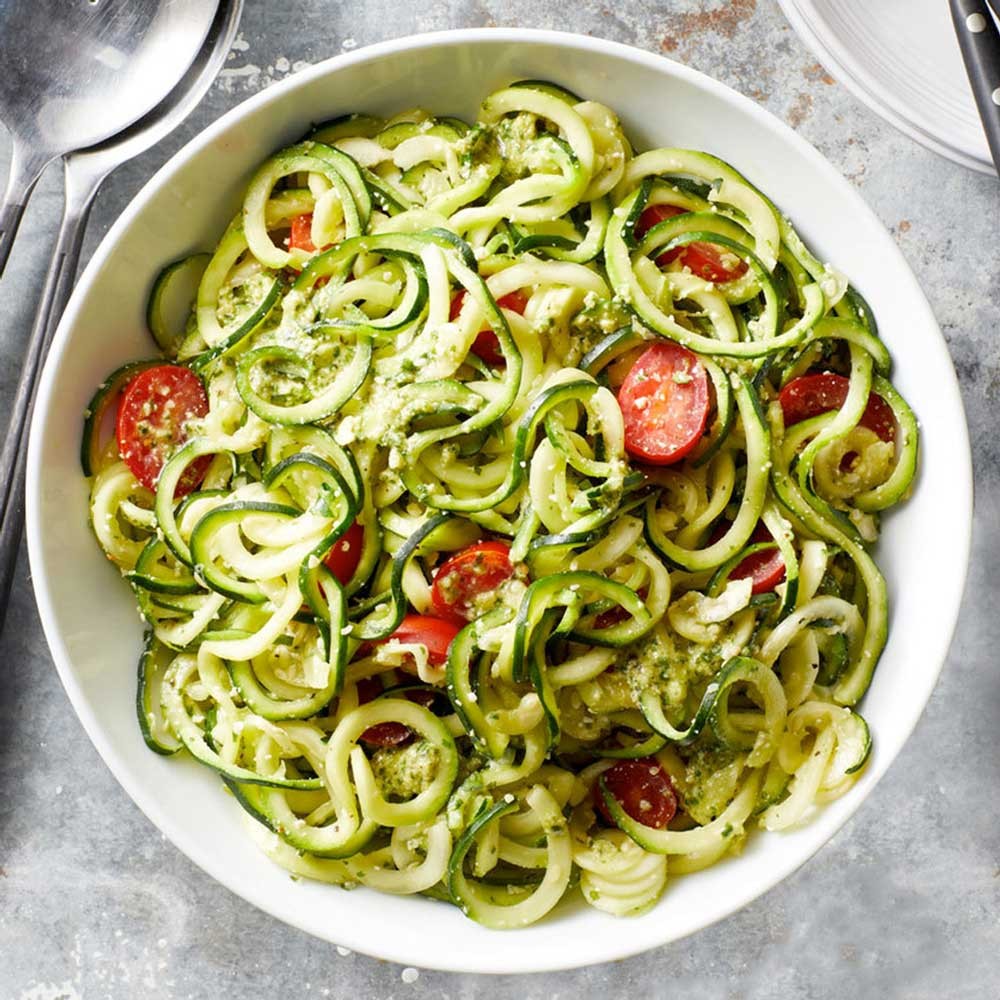 plate of zucchini noodles with garlic oil and cherry tomatoes