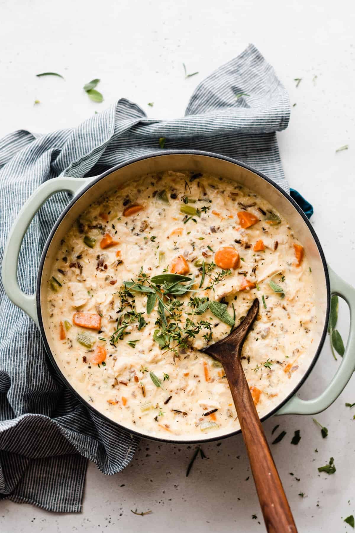 bowl of creamy chicken and wild rice soup with vegetables and herbs