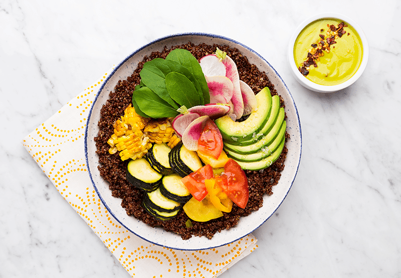 Vibrant healthy avocado dinner plate with fresh vegetables and grains