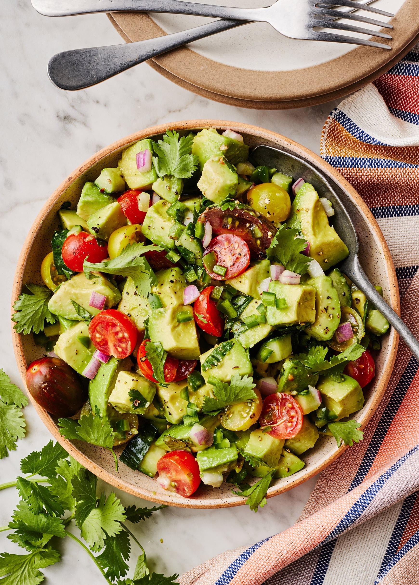 Vibrant healthy avocado dinner plate with fresh vegetables and lime