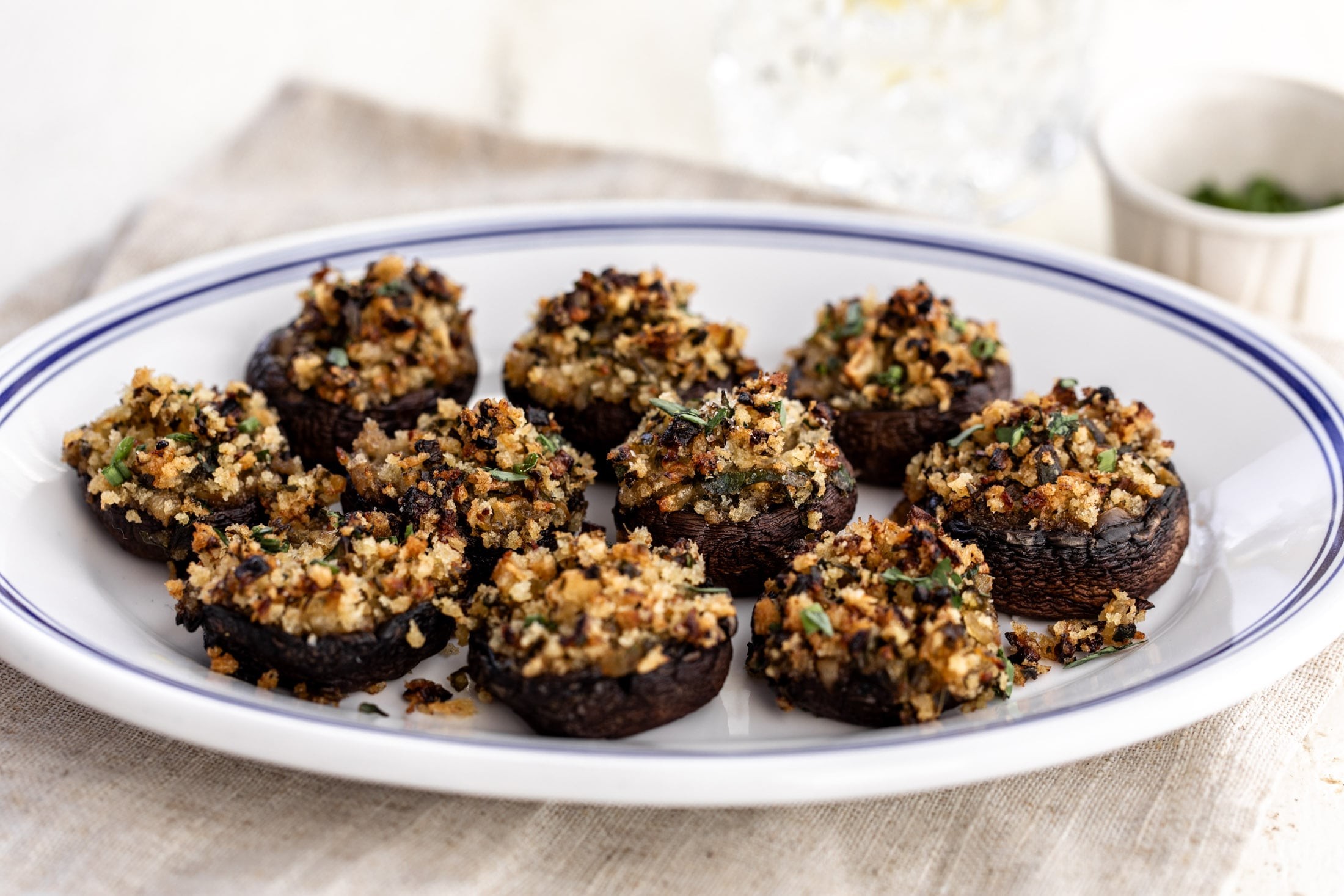 Platter of golden brown garlic herb stuffed mushrooms