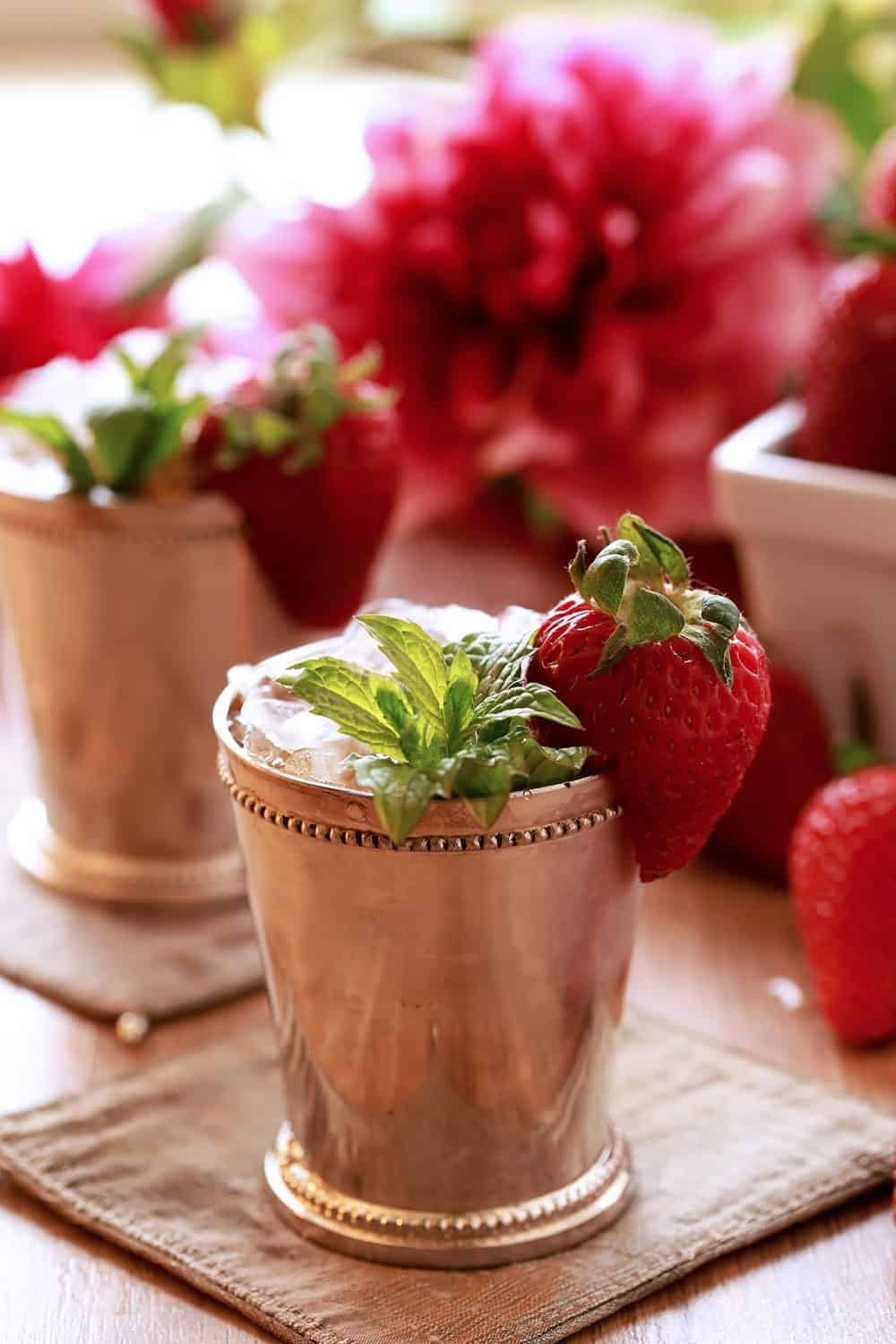 Strawberry Mint Oatmeal Julep in a glass with fresh strawberries and mint garnish