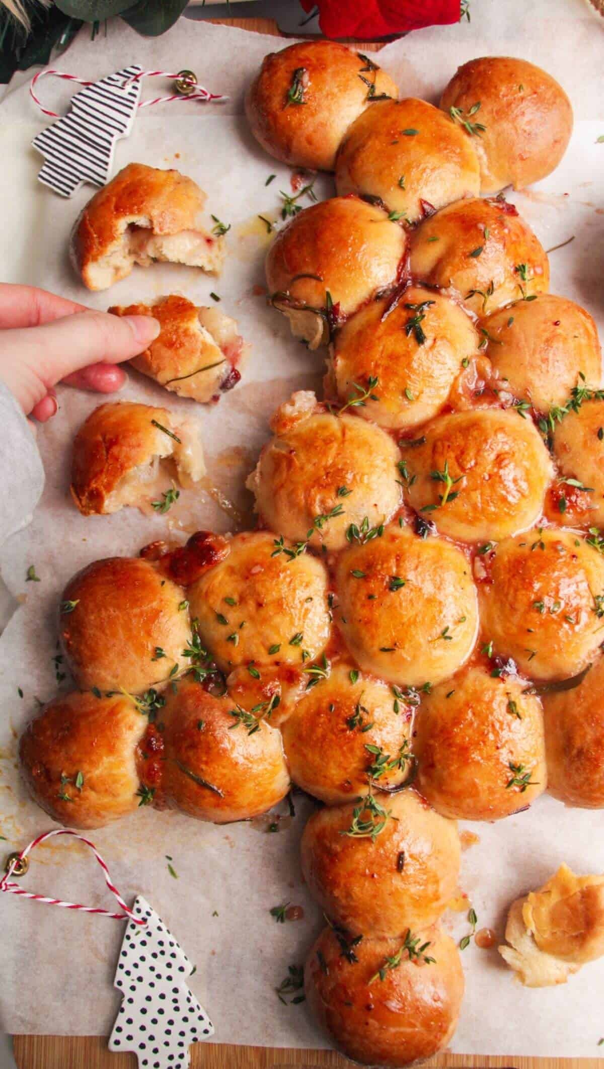 Garlic knots stuffed with gooey cheese, golden brown, on a festive holiday platter