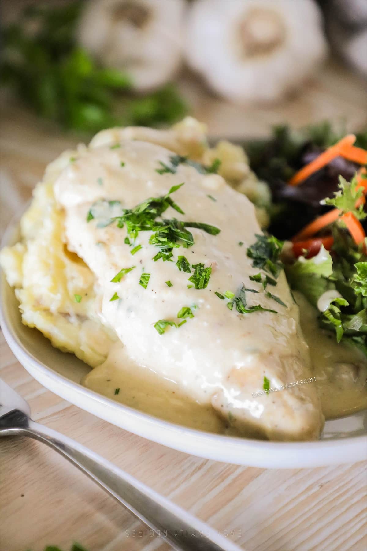 appetizing crockpot white garlic chicken, creamy sauce, served with parsley garnish