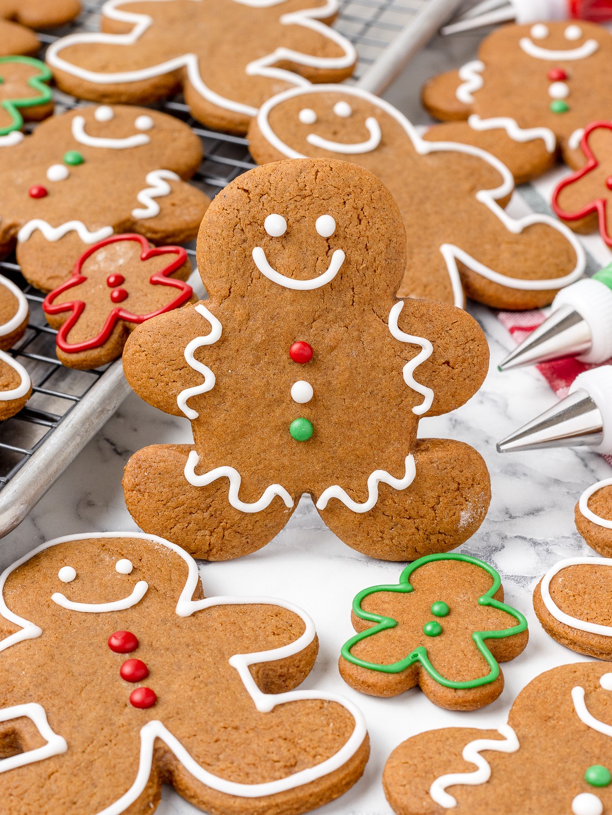 freshly baked iced ginger cookies with a dusting of cinnamon