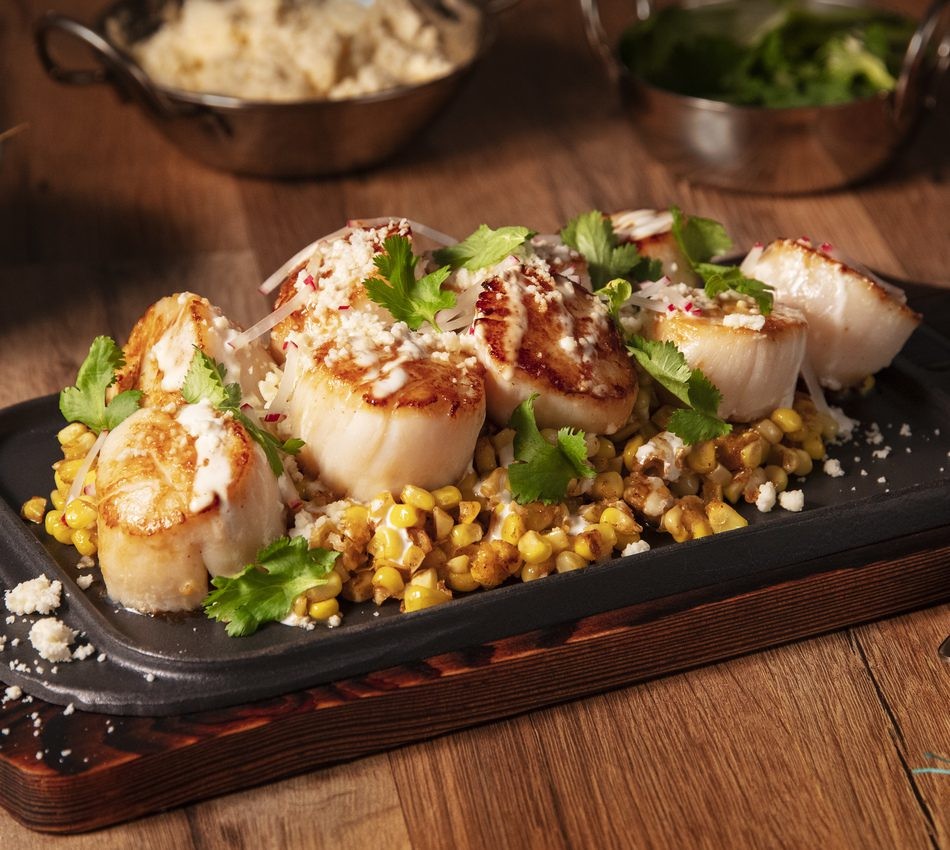 pan-seared scallops topped with elote and cotija cheese
