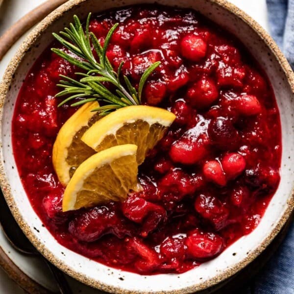 Homemade cranberry sauce with maple syrup drizzle in a festive bowl
