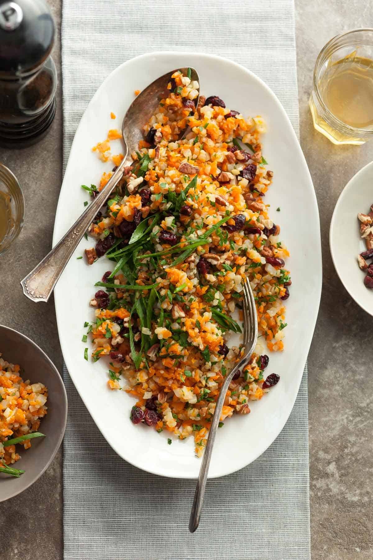 vibrant cauliflower rice pilaf with fresh green herbs in a serving bowl