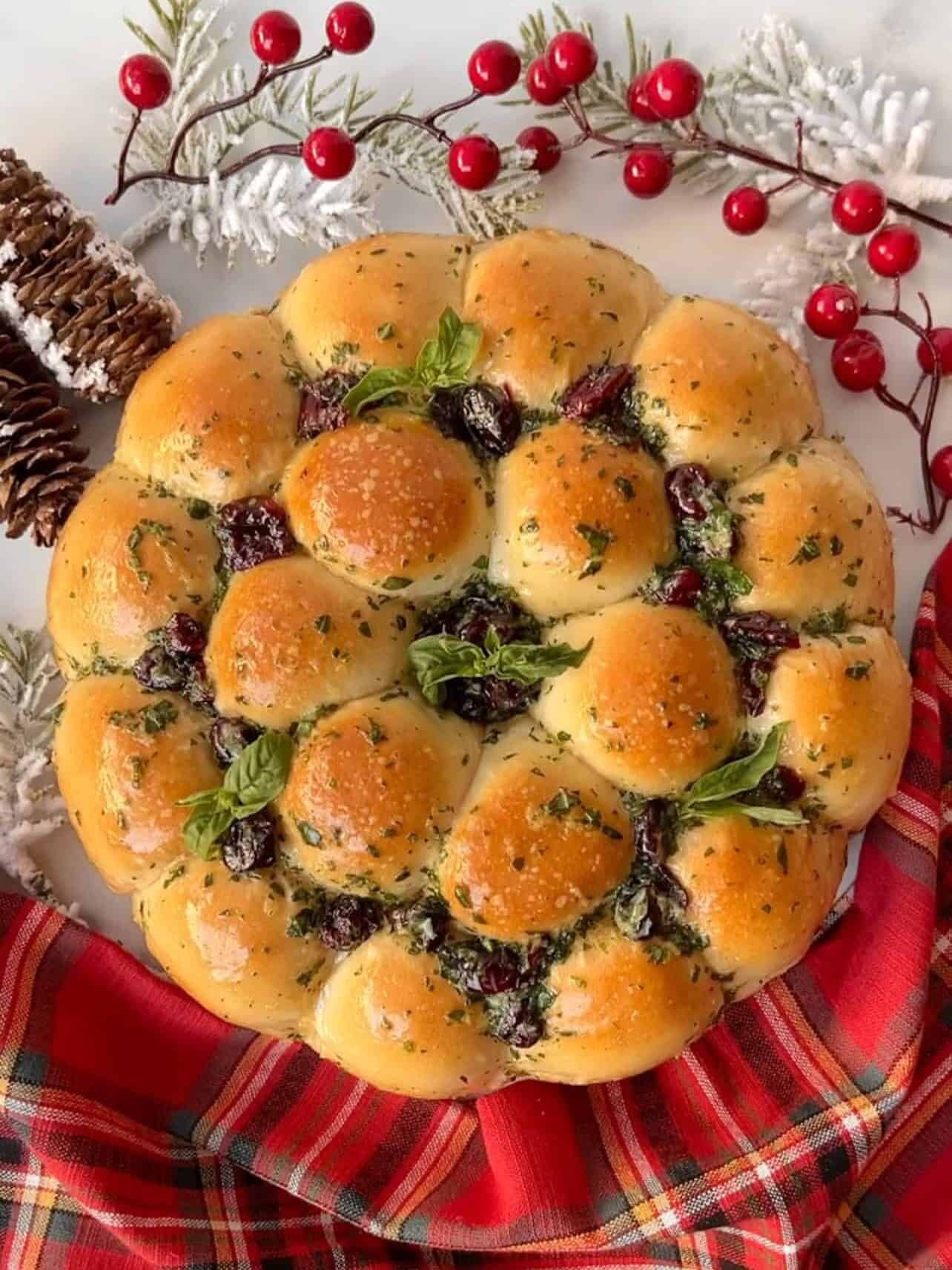 Platter of golden brown cheese stuffed garlic knots, garnished with fresh herbs for a festive holiday party