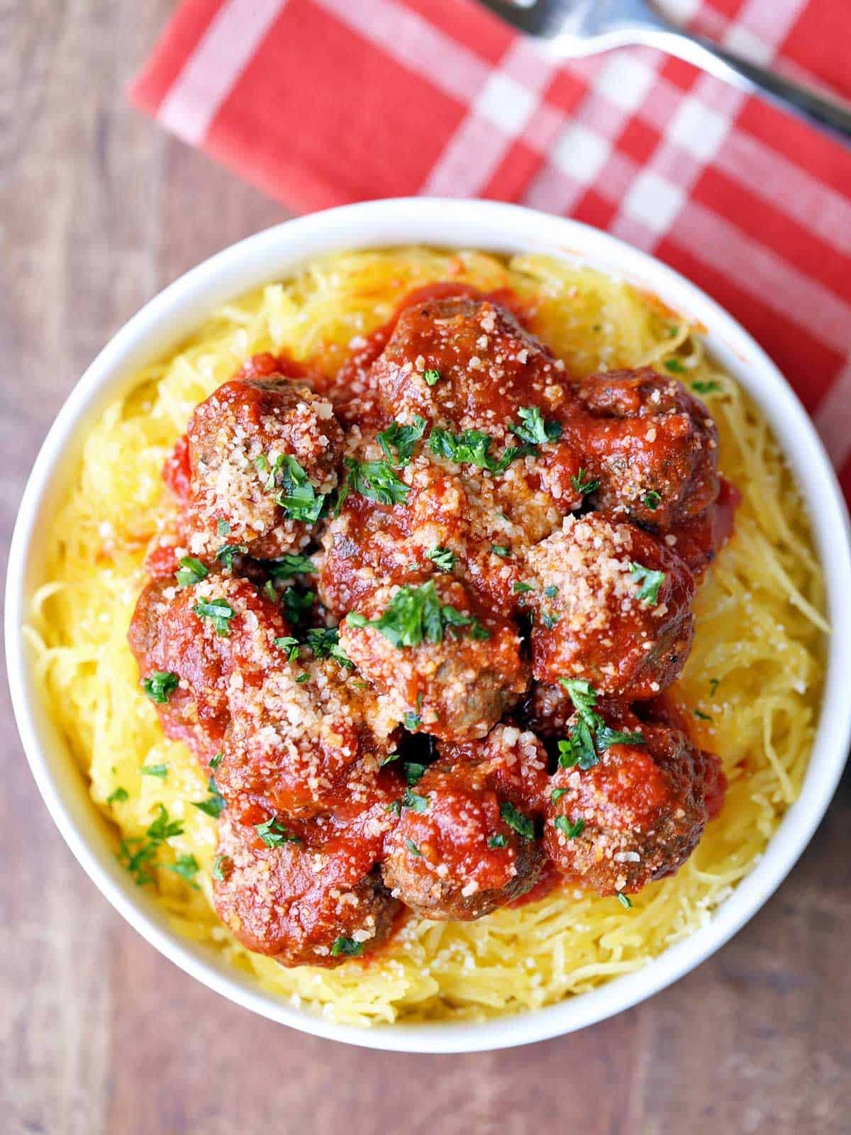 spaghetti squash with marinara sauce and meatballs on a plate